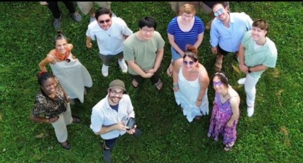 A group of students standing on the lawn and looking up
